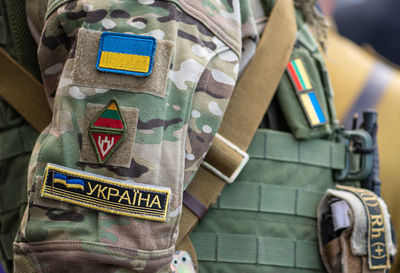 Midsection of soldier with gun