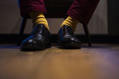 Low section of man on hardwood floor