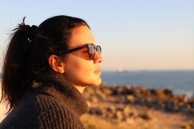 Portrait of young woman looking away outdoors