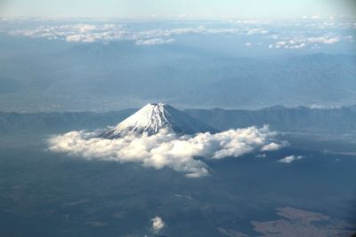 High angle view of snowed mountain amid clouds