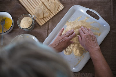 High angle view of woman preparing food on table