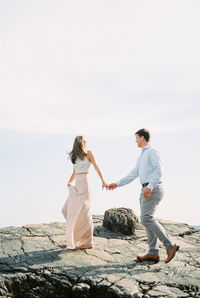 Full length of woman standing against sky