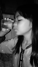 Close-up portrait of a girl drinking glass