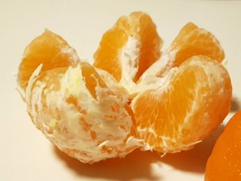 Close-up of orange fruit against white background