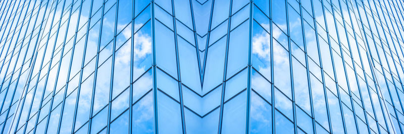 Full frame shot of glass wall against blue sky