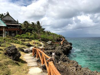 Scenic view of sea and houses against sky