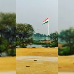 Scenic view of flag against sky