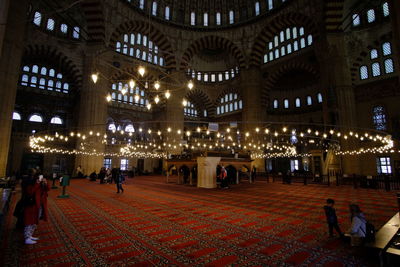 Group of people in illuminated building at night