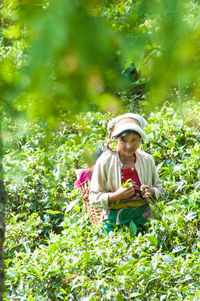 Full length of woman with flower in field