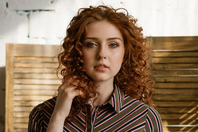 Portrait of a young red-haired woman with sad eyes