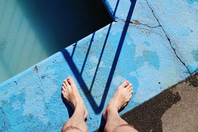 Low section of person standing in water