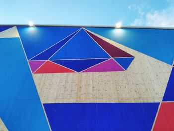 Multi colored building against blue sky