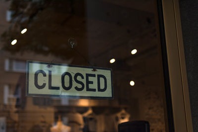 Close-up of illuminated text hanging on store