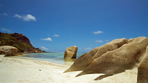 Rocks on beach against sky