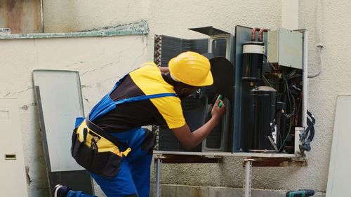 Rear view of man working at construction site