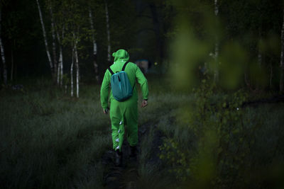 Rear view of man standing in forest