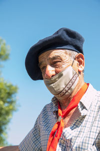 Portrait of man wearing face mask against sky