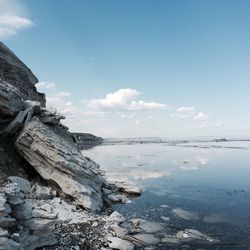 View of calm sea against cloudy sky