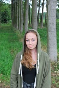 Portrait of smiling young woman in forest