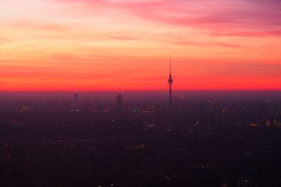 Aerial view of cityscape against sky during sunset