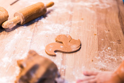 High angle view of person preparing gingerbread cookies on table