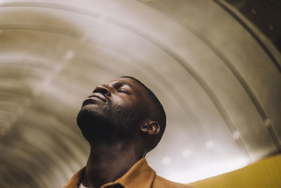 Low angle view of young man looking away