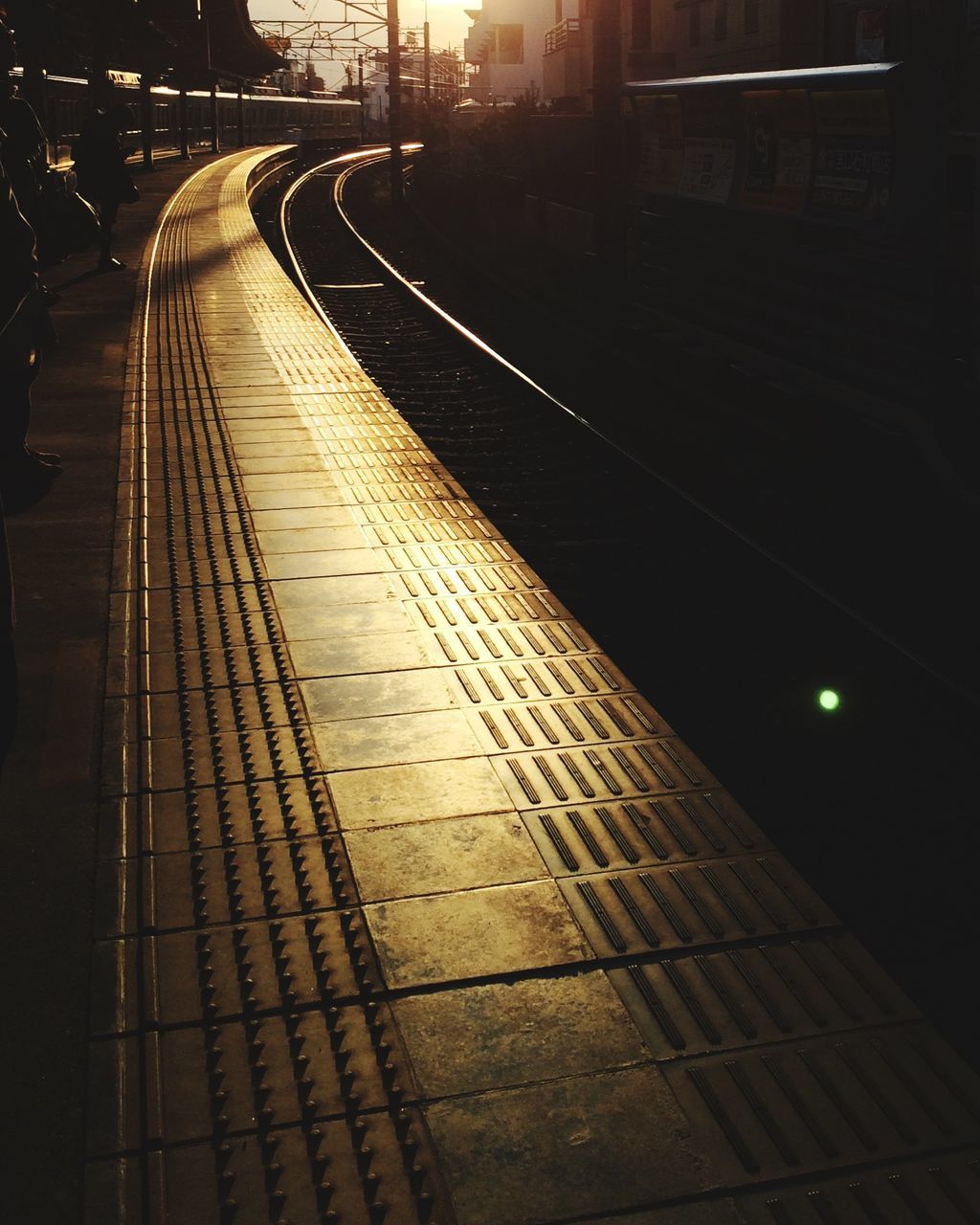 illuminated, transportation, night, railroad track, the way forward, built structure, architecture, diminishing perspective, vanishing point, high angle view, city, rail transportation, railroad station, railroad station platform, building exterior, connection, no people, public transportation, outdoors, railing