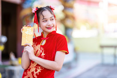 Portrait of smiling girl standing outdoors