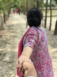 Rear view of woman walking outdoors
