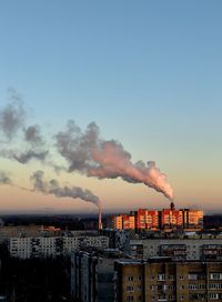 Cityscape against sky during sunset