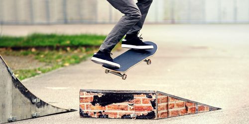 Low section of skateboarder jumping