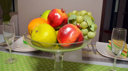 Fruits in bowl on table at home