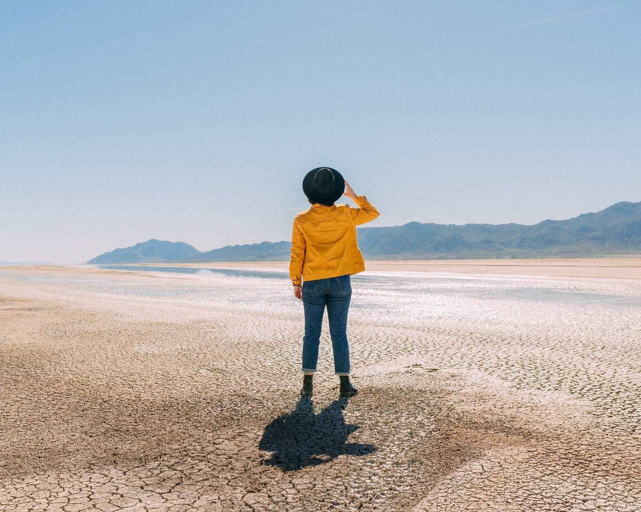 rear view, one person, standing, real people, full length, land, scenics - nature, lifestyles, mountain, sky, beauty in nature, leisure activity, casual clothing, nature, day, non-urban scene, copy space, tranquil scene, outdoors