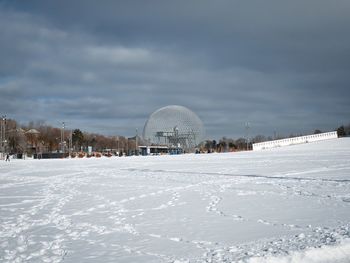 Snow covered field against sky