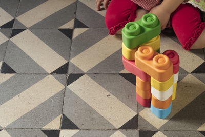 High angle view of toys with toy standing on tiled floor