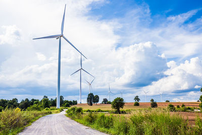 Windmill on field against sky