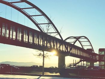 Bridge over river at sunset