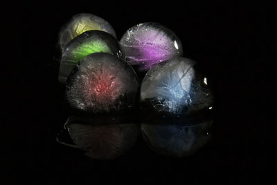 Close-up of fruits over black background