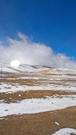 Scenic view of frozen landscape against sky