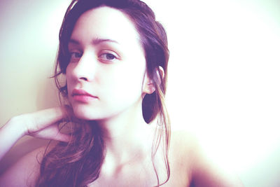 Close-up portrait of young woman over white background