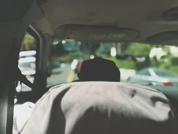 Rear view of man driving car