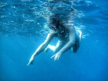 Woman scuba diving in sea