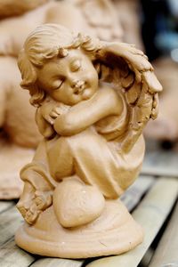 Close-up of angel figurine on table
