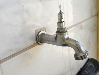 Close-up of faucet in bathroom