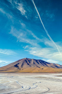 Scenic view of snowcapped mountains against blue sky