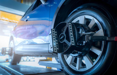 Wheel alignment equipment grip the tire of car wheel in car repair shop. auto wheel alignment 