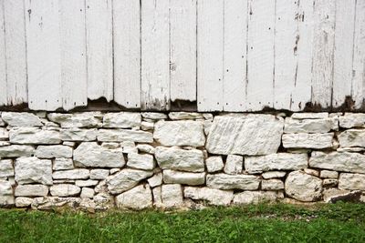 View of stone whitewashed  foundation wall of old barn