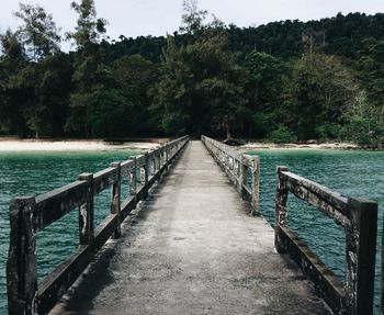Pier over lake against sky