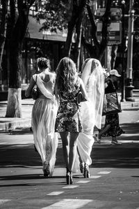 Rear view of women walking on road