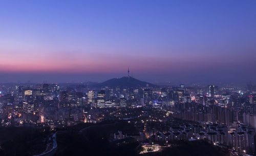 Illuminated cityscape against sky at night